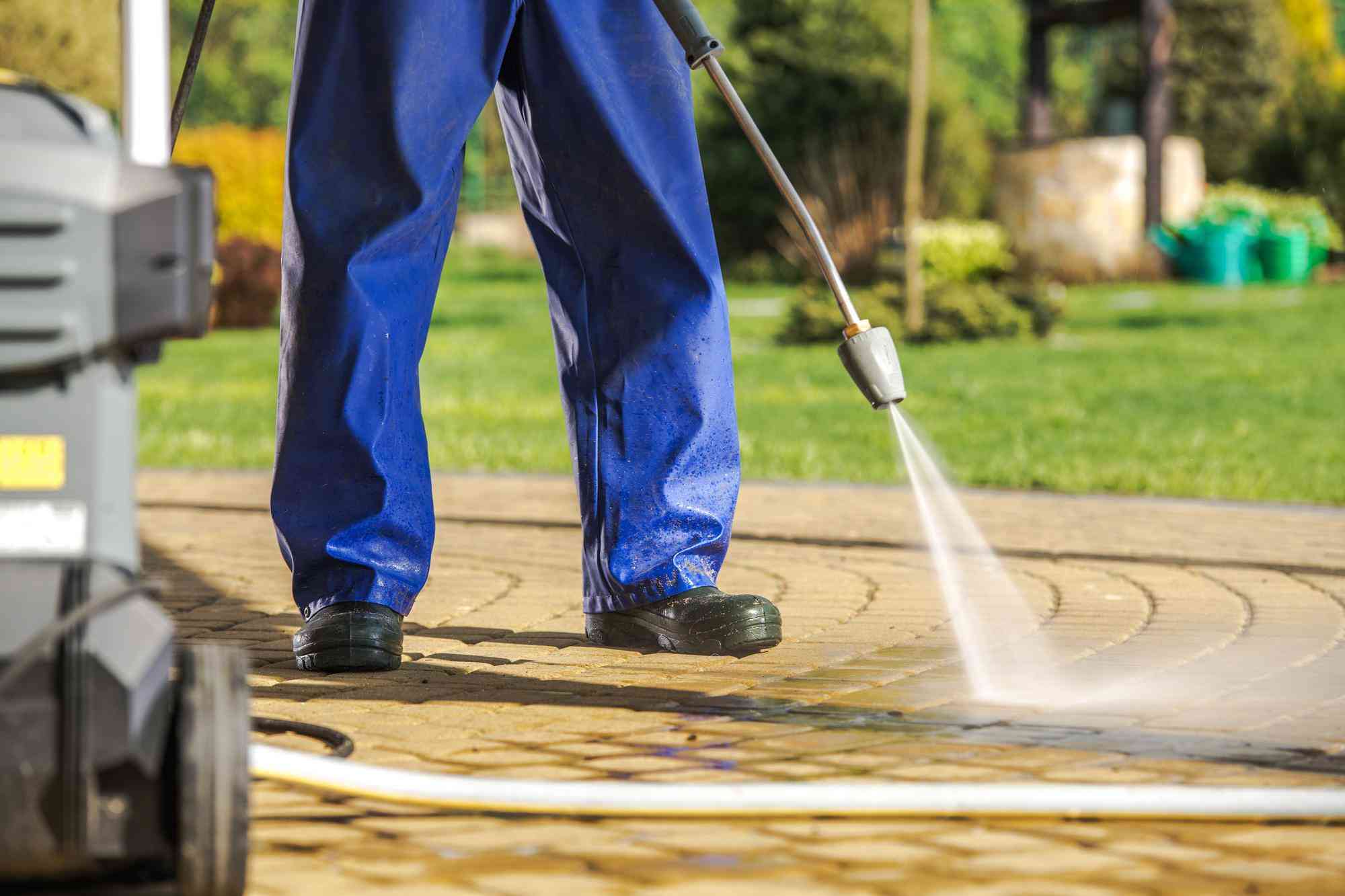 Pressure washing a paved driveway